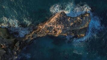 Top view of the powerful turquoise waves crashing against the rocks of Macao into thousands of sparkling splashes in the Dominican Republic at sunset of the warm sun. video