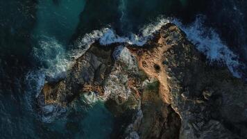 Top view of the powerful turquoise waves crashing against the rocks of Macao into thousands of sparkling splashes in the Dominican Republic at sunset of the warm sun. video