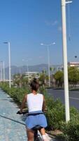 A Cyclist is Enjoying a Beautiful and Sunny Day on a Scenic Pathway Surrounded by Nature video