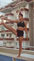 An Elegant Yoga Pose Performed on a Rooftop with a Stunning City View in the Background video