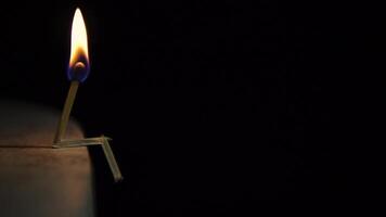 burning match on a light surface on a black background. The concept of a sad person. HD video