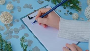 Handwritten new year resolutions aims goals on paper notepad. Preparation for New Year. Concept of planning and setting goals for personal development video