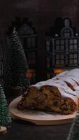 Vertical footage Homemade Christmas traditional cake pie with marzipan nuts and dried fruits pastry dessert stollen. Winter holidays season atmosphere. Delicious tasty composition home table setting video