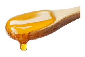 Honey dripping from a wooden dipper isolated on transparent background. png