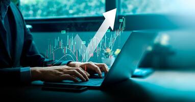 Businessman Analyzing Stock Market Trends on Laptop and Tablet with Upward Arrow and Trading Data, Representing Financial Growth and Investment Strategies in Modern Technology, Forex Trading photo