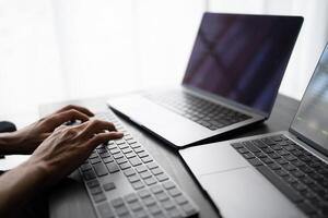 Asian man software engineer Working on Computer at office desk for writing program code IT Software Engineer finding errors tech support devops creating digital photo