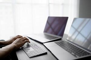 Asian man software engineer Working on Computer at office desk for writing program code IT Software Engineer finding errors tech support devops creating digital photo