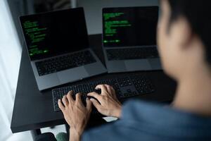 Asian man software engineer Working on Computer at office desk for writing program code IT Software Engineer finding errors tech support devops creating digital photo