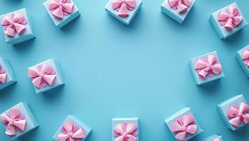 Frame of blue gift boxes with pink bows on light blue background. Flat lay, top view, copy space. photo