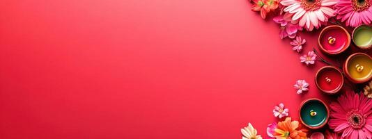 Colorful aromatherapy candles and flowers on red background with copy space photo