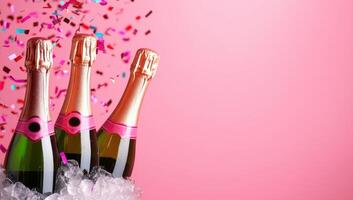Three champagne bottles in ice bucket with confetti on pink background photo