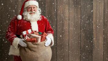 Smiling Santa Claus holding a sack full of gifts against a rustic wooden background. photo