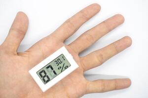 humidity measuring thermometer, small size, portable, with a white background. photo