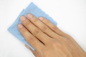 top view of hand with cleaning cloth isolated on white background photo
