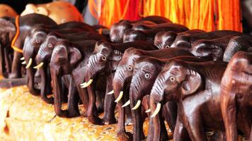 Wooden carved elephant sculptures displayed in a handicraft shop photo