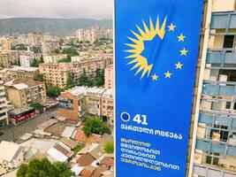 Tbilisi, Georgia - 9th august, 2024- Aerial view giant dreamers party political agitation billboards on city buildings in Giorgi Saakadze square. Georgian Dream ruling political party in Georgia. photo