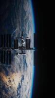 International space station in dark starry space, vertical video