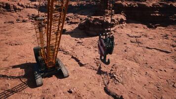 A large crane sitting on top of a dirt field video