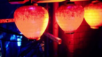 Three red and yellow lanterns hanging from a pole video