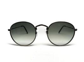 Sunglasses in an iron frame with black glass isolated on white background. Sunglasses in an iron frame with black glass isolated on white background. Close up photo
