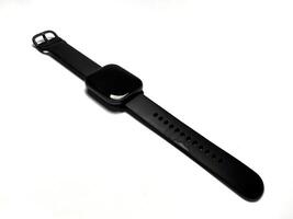 Black smart watch isolated on white background. Smartwatch that has been used with black strap. Copy space for text. photo