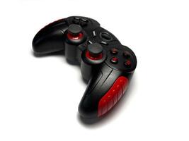 Gamepad isolated on white background. Black joystick with red and black buttons photo
