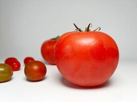 Close up of fresh tomato and cherry tomato. Healthy vegetables. Food ingredient. Vegetables background photo