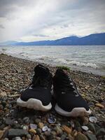 A pair of shoes on the shore of Lake Singkarak, West Sumatra photo
