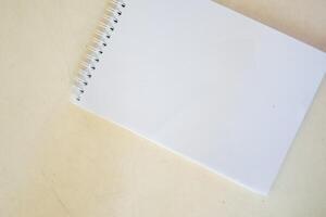 blank notebook on white table, business concept photo