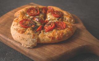 Lush pizza with two types of cheese, tomatoes and spices photo