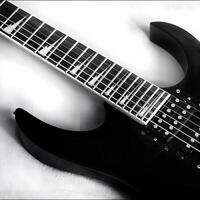 a black electric guitar with a white background photo