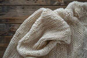 A white sweater on a wooden table photo