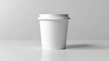 A white coffee cup on a table with a copy of the paper photo