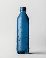 A blue plastic bottle with water droplets on it photo