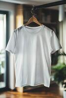 White t - shirt hanging on a hanger in front of a window photo