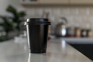 A black coffee cup sitting on a counter photo