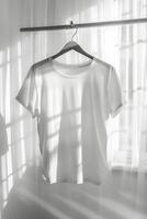 A white t - shirt hanging on a hanger photo