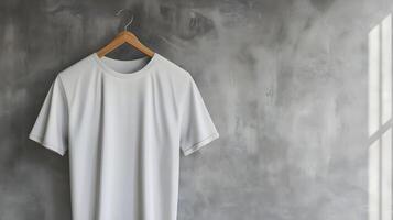 White t - shirt hanging on a wooden hanger photo