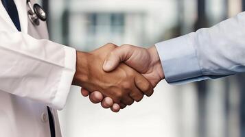 Two doctors shaking hands in an office hallway photo
