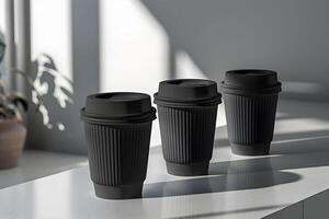 Three black coffee cups sit on a table photo