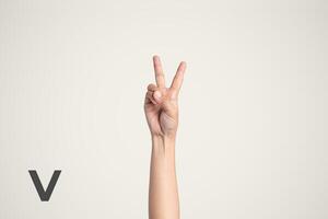 Deaf Sign alphabet of V, American Sign Language ASL. Isolated object Finger spelling the alphabet photo
