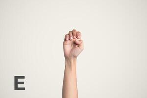 Deaf Sign alphabet of E, American Sign Language ASL. Isolated object Finger spelling the alphabet photo