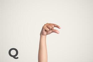 Deaf Sign alphabet of Q, American Sign Language ASL. Isolated object Finger spelling the alphabet photo