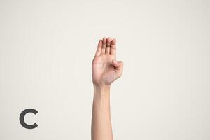 Deaf Sign alphabet of C, American Sign Language ASL. Isolated object Finger spelling the alphabet photo