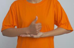Giving a thumbs up with the other hand open and flat. Sign language photo