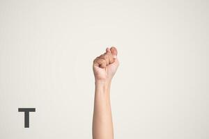 Deaf Sign alphabet of T, American Sign Language ASL. Isolated object Finger spelling the alphabet photo