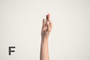 Deaf Sign alphabet of F, American Sign Language ASL. Isolated object Finger spelling the alphabet photo