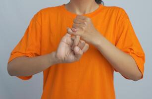 A person snapping their finger and showing friendship sign or symbol with their hands photo