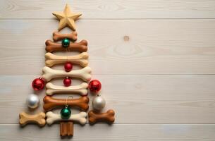 Christmas tree made of dog bones with ornaments and a star on a wooden background photo
