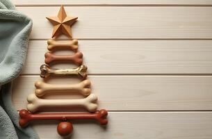 Christmas tree made of dog bones with ornaments and a star on a wooden background photo